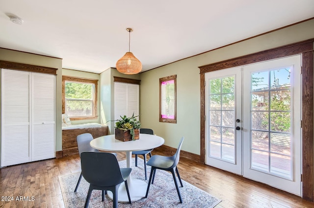 dining area with light wood-type flooring, french doors, and baseboards