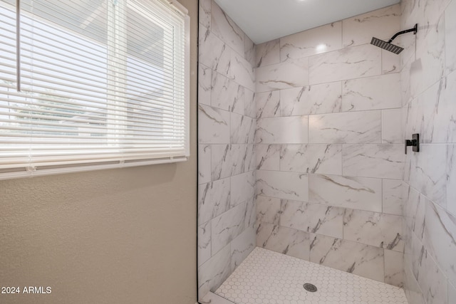 bathroom with tiled shower