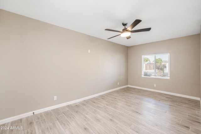 empty room with ceiling fan and light wood-type flooring