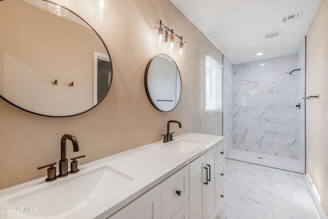 bathroom with vanity and tiled shower