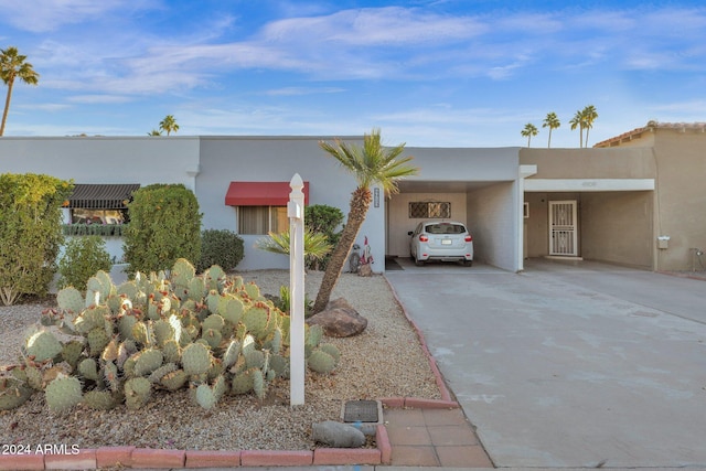 view of front of home with a carport