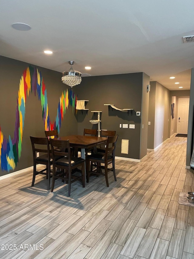3211 W Pollack St, Phoenix, AZ 85041 - dining room featuring light wood-style flooring, baseboards, recessed lighting, and a chandelier