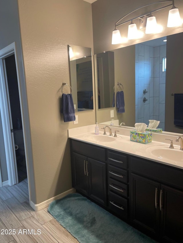 3211 W Pollack St, Phoenix, AZ 85041 - full bath featuring double vanity, a tile shower, wood finished floors, and baseboards