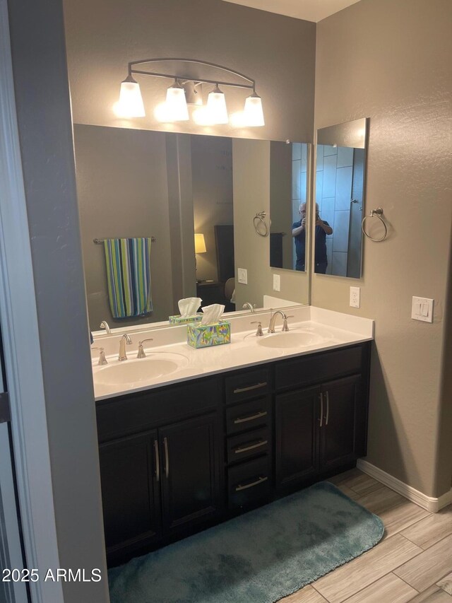 3211 W Pollack St, Phoenix, AZ 85041 - full bath with double vanity, wood finished floors, and baseboards