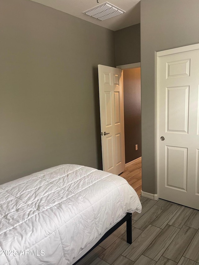 3211 W Pollack St, Phoenix, AZ 85041 - bedroom featuring wood tiled floors and baseboards