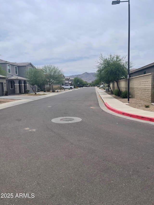 3211 W Pollack St, Phoenix, AZ 85041 - view of asphalt road with sidewalks and curbs