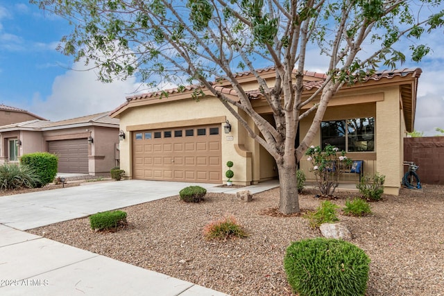 view of front of home featuring a tile roof, stucco siding, concrete driveway, and a garage