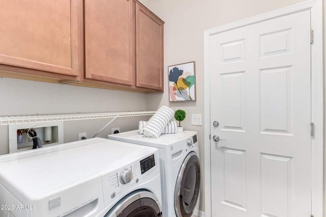 laundry area featuring washing machine and dryer and cabinet space