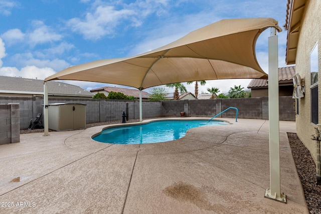 view of swimming pool with a fenced in pool, a fenced backyard, and a patio area