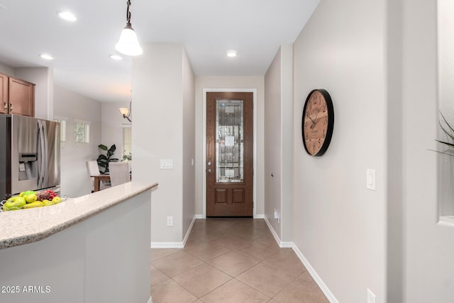 entrance foyer featuring light tile patterned flooring, recessed lighting, and baseboards