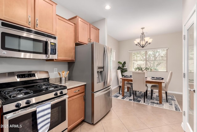 kitchen with decorative light fixtures, recessed lighting, stainless steel appliances, light tile patterned floors, and a chandelier