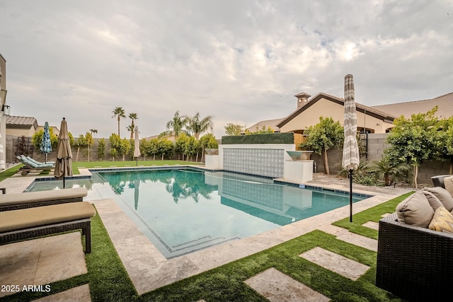 view of swimming pool with a patio