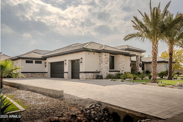 view of front of property featuring a garage and central air condition unit