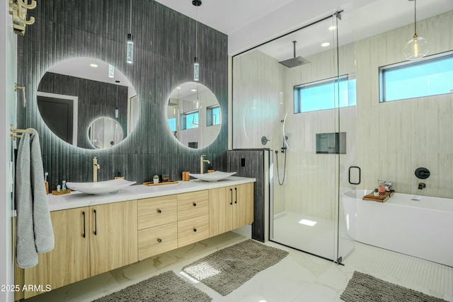 bathroom featuring vanity, separate shower and tub, and tile walls