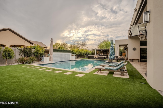 view of pool featuring a patio and a lawn