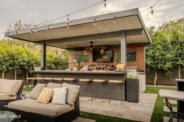 view of patio / terrace featuring an outdoor hangout area and an outdoor bar