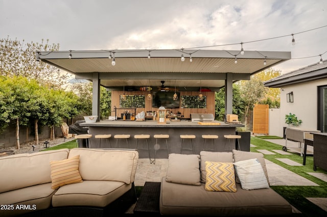 view of patio featuring a bar, outdoor lounge area, and an outdoor kitchen