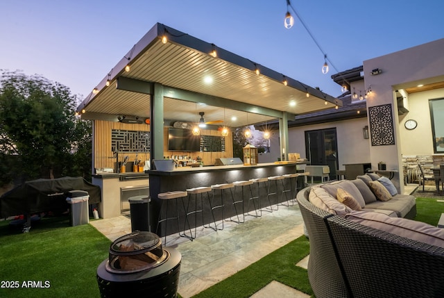 exterior space featuring ceiling fan, an outdoor hangout area, an outdoor bar, and a patio area