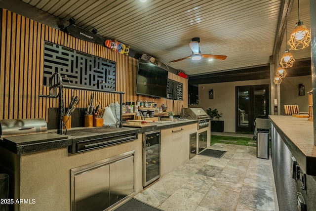 kitchen with wine cooler, decorative light fixtures, and ceiling fan