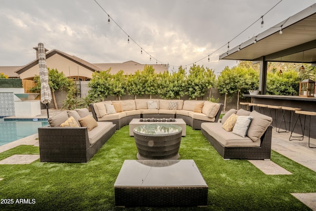 view of patio with a fenced in pool, an outdoor hangout area, and a bar