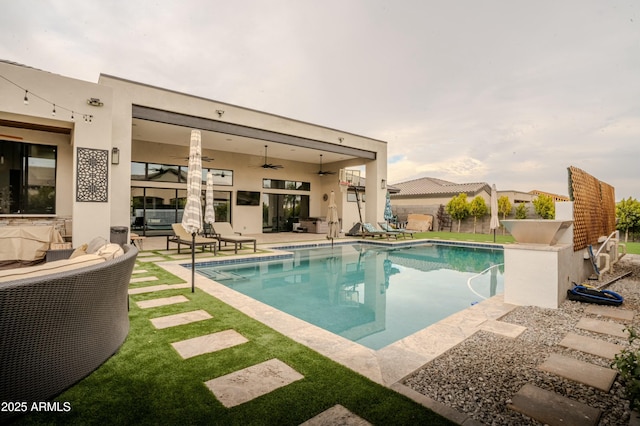 view of pool with a patio, outdoor lounge area, and ceiling fan