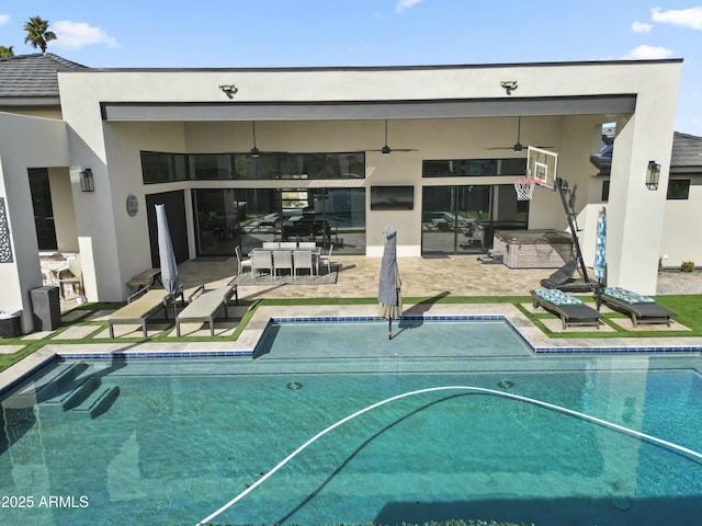 view of swimming pool featuring a patio and ceiling fan