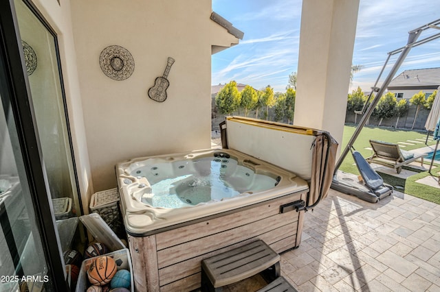 view of patio / terrace with a hot tub