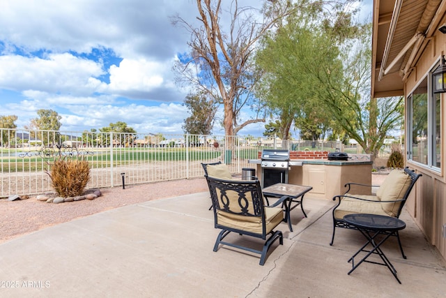 view of patio / terrace with a grill, fence, area for grilling, and outdoor dining space