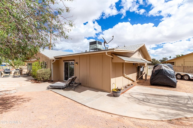 rear view of property with a patio and central air condition unit