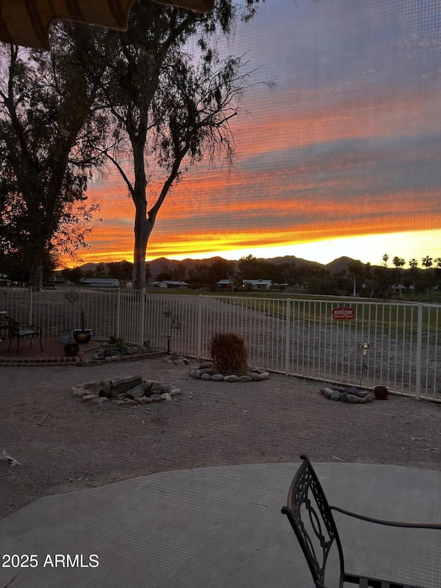 view of yard featuring fence and a mountain view