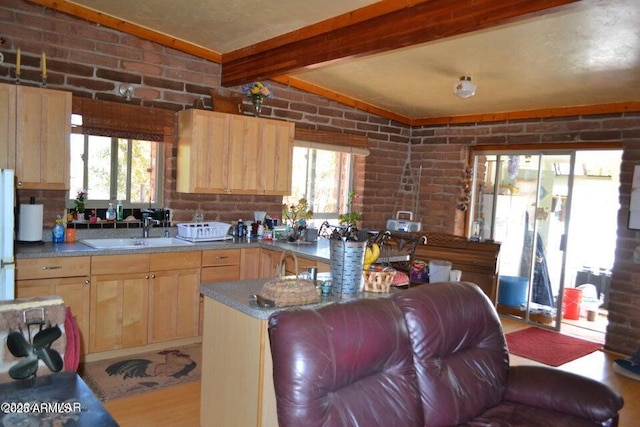3733 Del Contento Rd, Snowflake, AZ 85937 - kitchen featuring light brown cabinetry, a sink, brick wall, and freestanding refrigerator