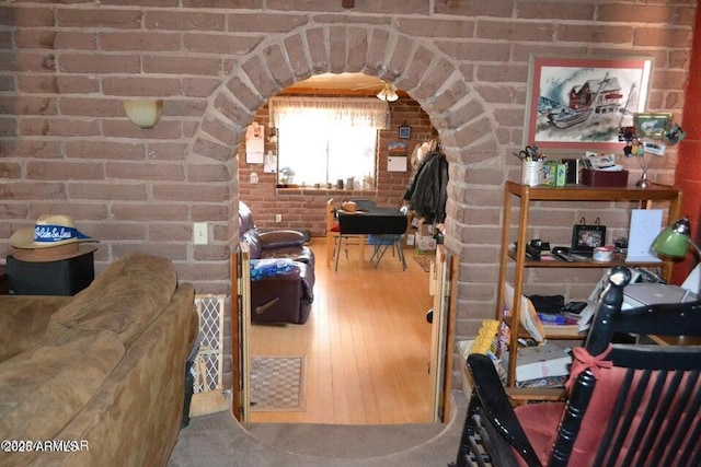 3733 Del Contento Rd, Snowflake, AZ 85937 - interior space featuring arched walkways, wood finished floors, and brick wall