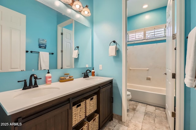 8115 W San Miguel Ave, Glendale, AZ 85303 - bathroom featuring double vanity, a sink, stone tile floors, and toilet