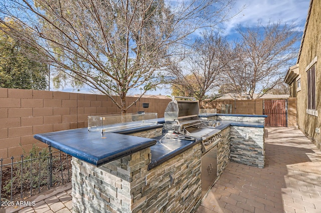 8115 W San Miguel Ave, Glendale, AZ 85303 - view of patio / terrace with an outdoor kitchen and a fenced backyard