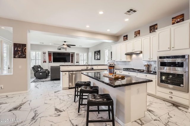 8115 W San Miguel Ave, Glendale, AZ 85303 - kitchen with a sink, marble finish floor, a peninsula, stainless steel appliances, and visible vents