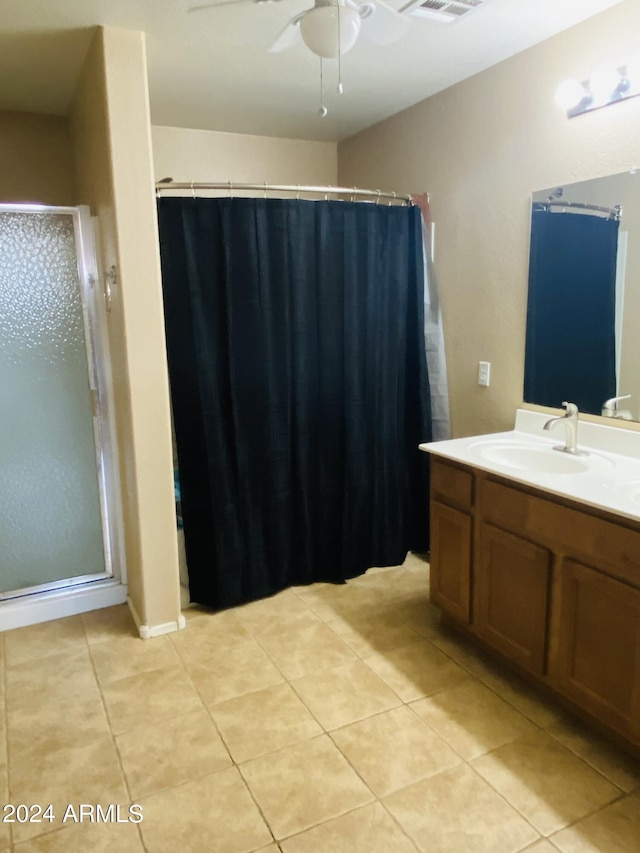 5881 E Sunrise Cir, Florence, AZ 85132 - bathroom with visible vents, ceiling fan, vanity, a stall shower, and tile patterned flooring