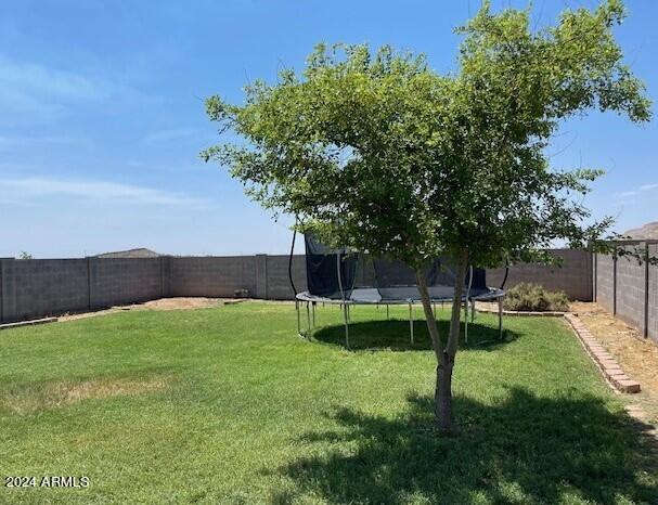 5881 E Sunrise Cir, Florence, AZ 85132 - view of yard with a fenced backyard and a trampoline