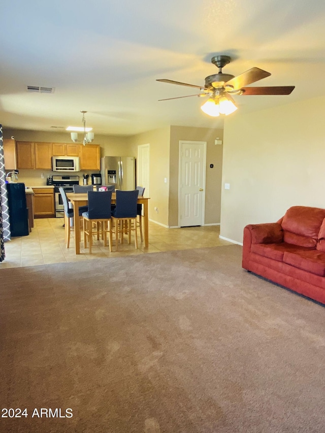 5881 E Sunrise Cir, Florence, AZ 85132 - dining area with visible vents, baseboards, a ceiling fan, light tile patterned floors, and light colored carpet