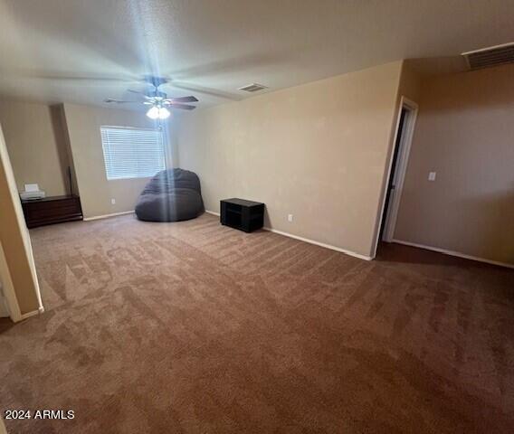 5881 E Sunrise Cir, Florence, AZ 85132 - interior space with carpet, baseboards, ceiling fan, and visible vents