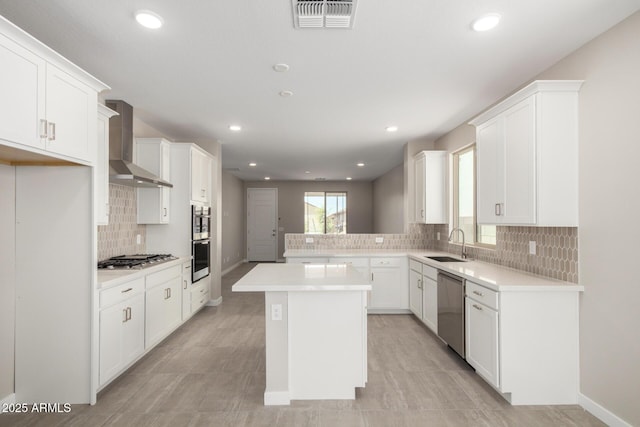 17032 W Cavedale Dr, Surprise, AZ 85387 - kitchen featuring wall chimney exhaust hood, appliances with stainless steel finishes, decorative backsplash, light countertops, and white cabinetry