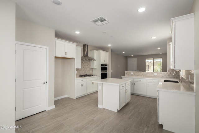 17032 W Cavedale Dr, Surprise, AZ 85387 - kitchen featuring wall chimney exhaust hood, stainless steel appliances, decorative backsplash, white cabinetry, and recessed lighting