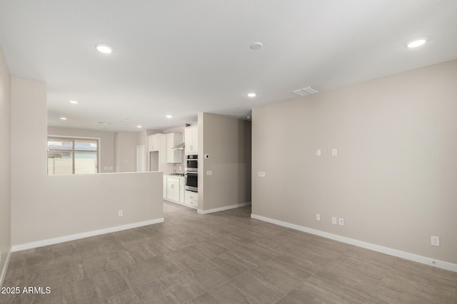 17032 W Cavedale Dr, Surprise, AZ 85387 - unfurnished living room featuring recessed lighting and baseboards