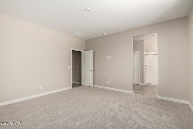 17032 W Cavedale Dr, Surprise, AZ 85387 - unfurnished bedroom with light carpet and ensuite bath