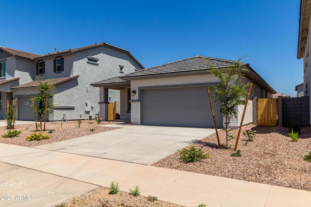 17032 W Cavedale Dr, Surprise, AZ 85387 - view of front of property featuring driveway, stucco siding, an attached garage, a tile roof, and a gate