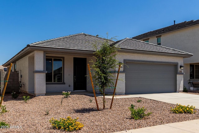 17032 W Cavedale Dr, Surprise, AZ 85387 - view of front of house featuring concrete driveway, a tile roof, a garage, and stucco siding
