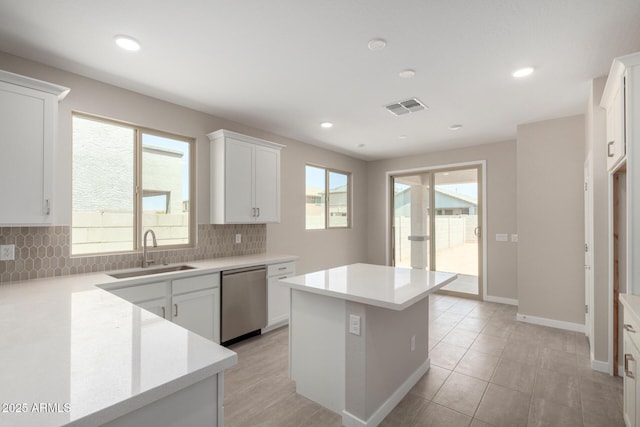 17032 W Cavedale Dr, Surprise, AZ 85387 - kitchen with stainless steel dishwasher, backsplash, light countertops, a kitchen island, and white cabinets