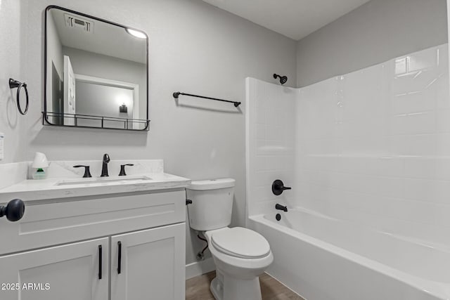 full bathroom with vanity, wood-type flooring, shower / tub combination, and toilet