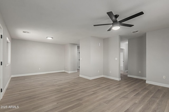 spare room featuring ceiling fan and light hardwood / wood-style flooring