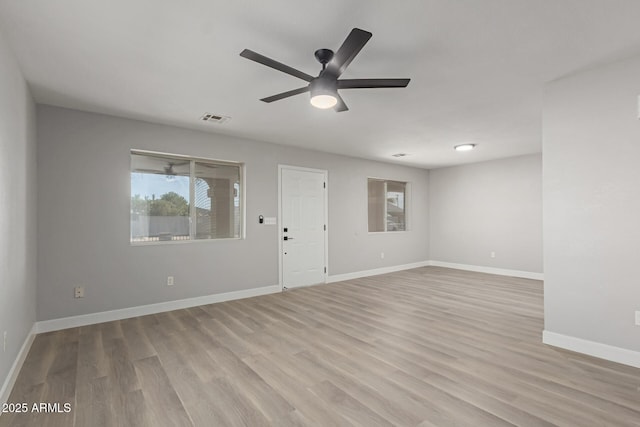 empty room with ceiling fan and light hardwood / wood-style floors