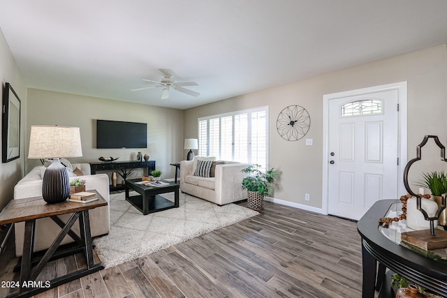 living room featuring hardwood / wood-style flooring and ceiling fan